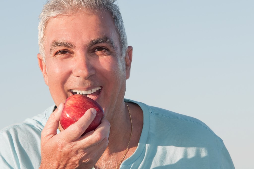 Old man eating an apple