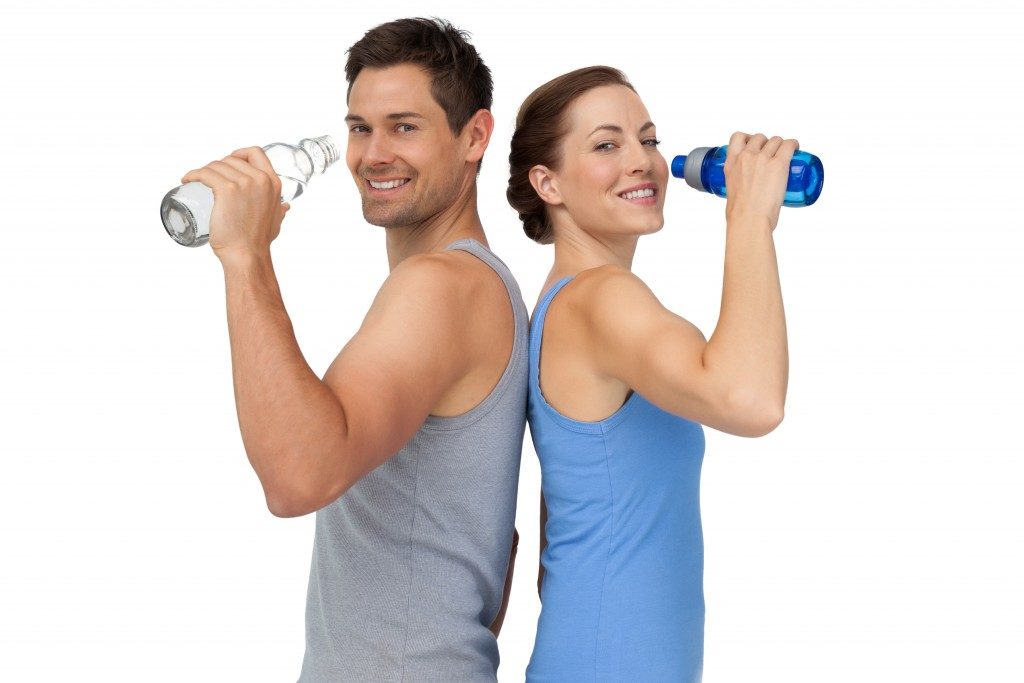 Fit couple drinking water