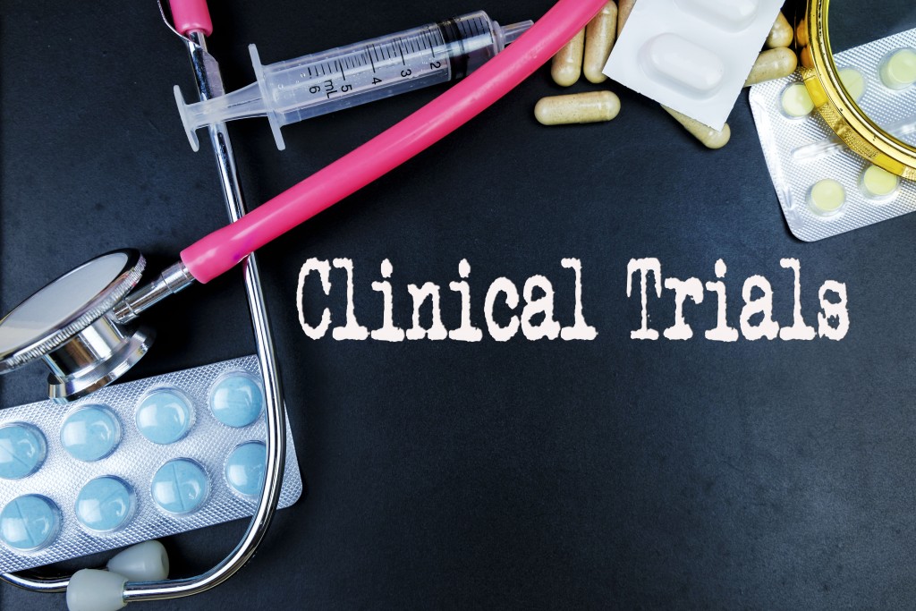 Clinical Trials word with medical supplies