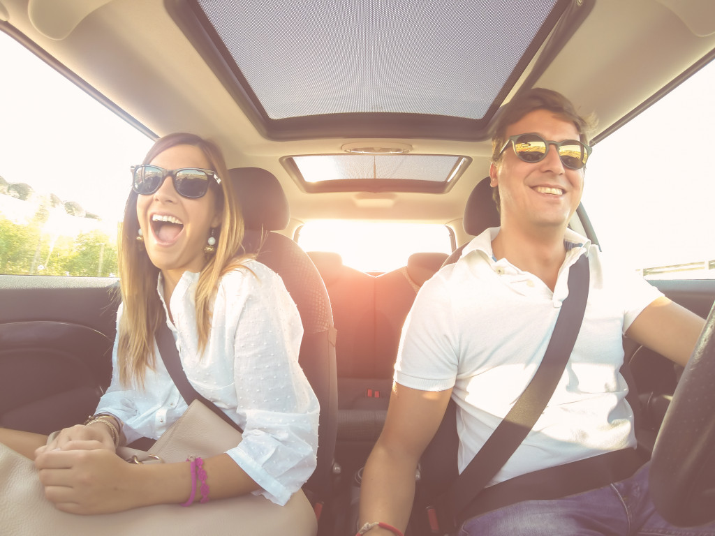 two people in a car wearing seatbelts