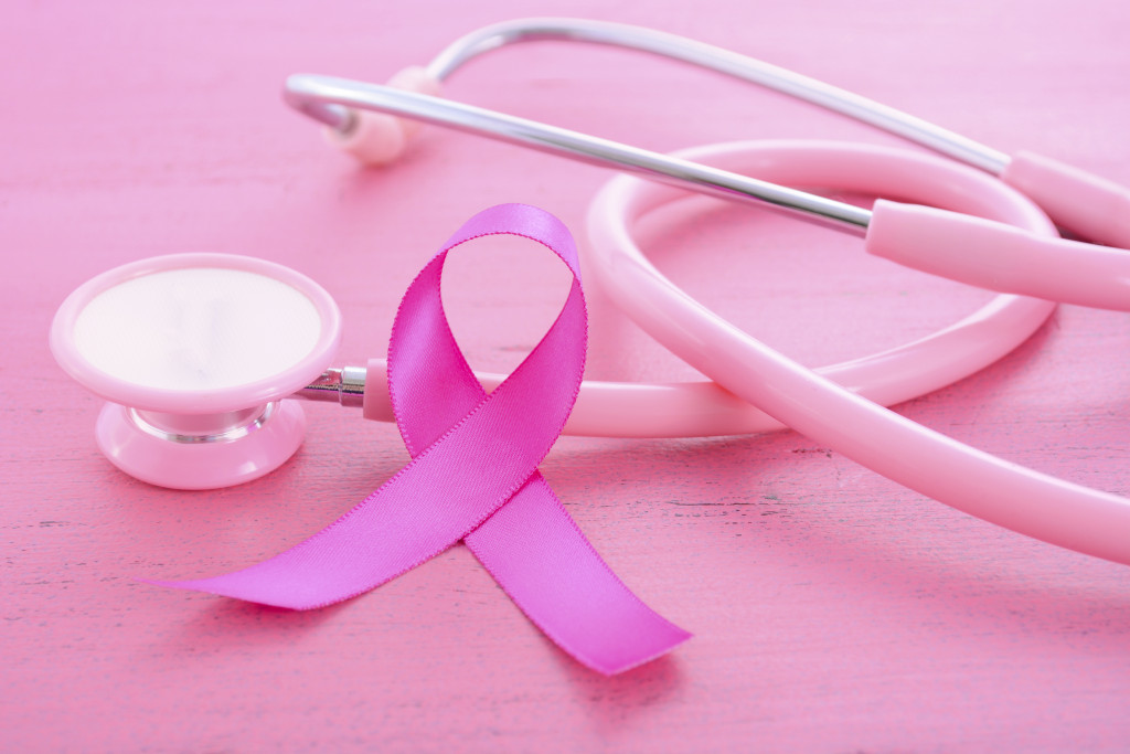 breast cancer awareness shown through pink ribbon and stethoscope