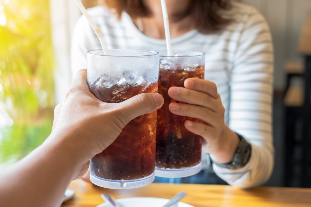 two people drinking coke or soda