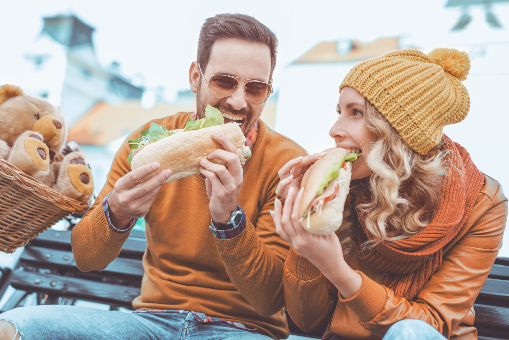 A couple eating sandwiches