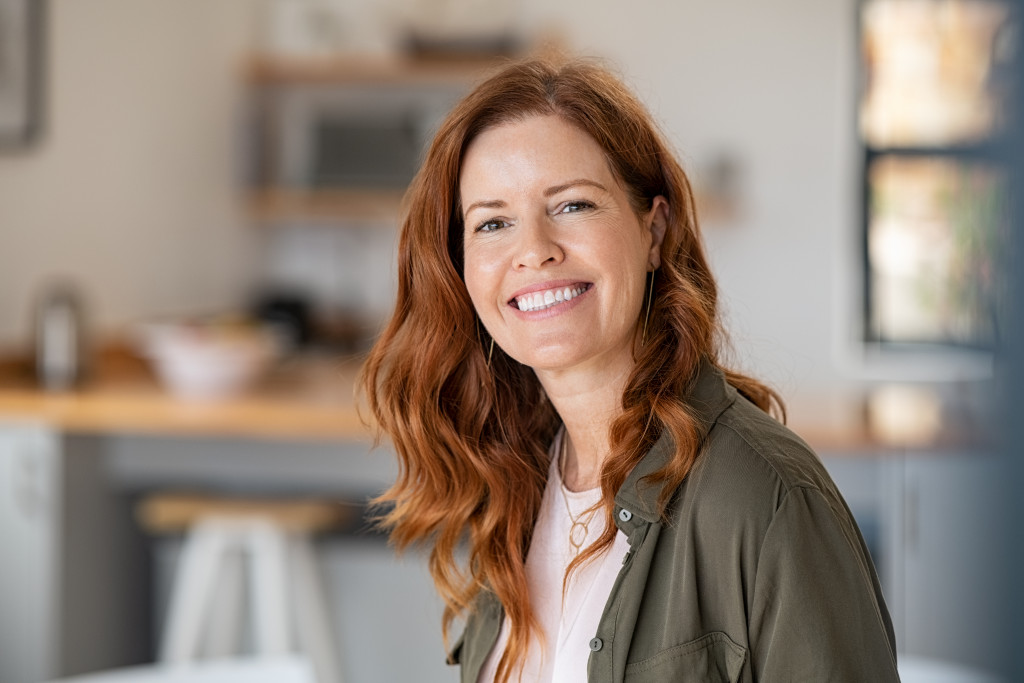 Successful middle aged woman at home smiling.