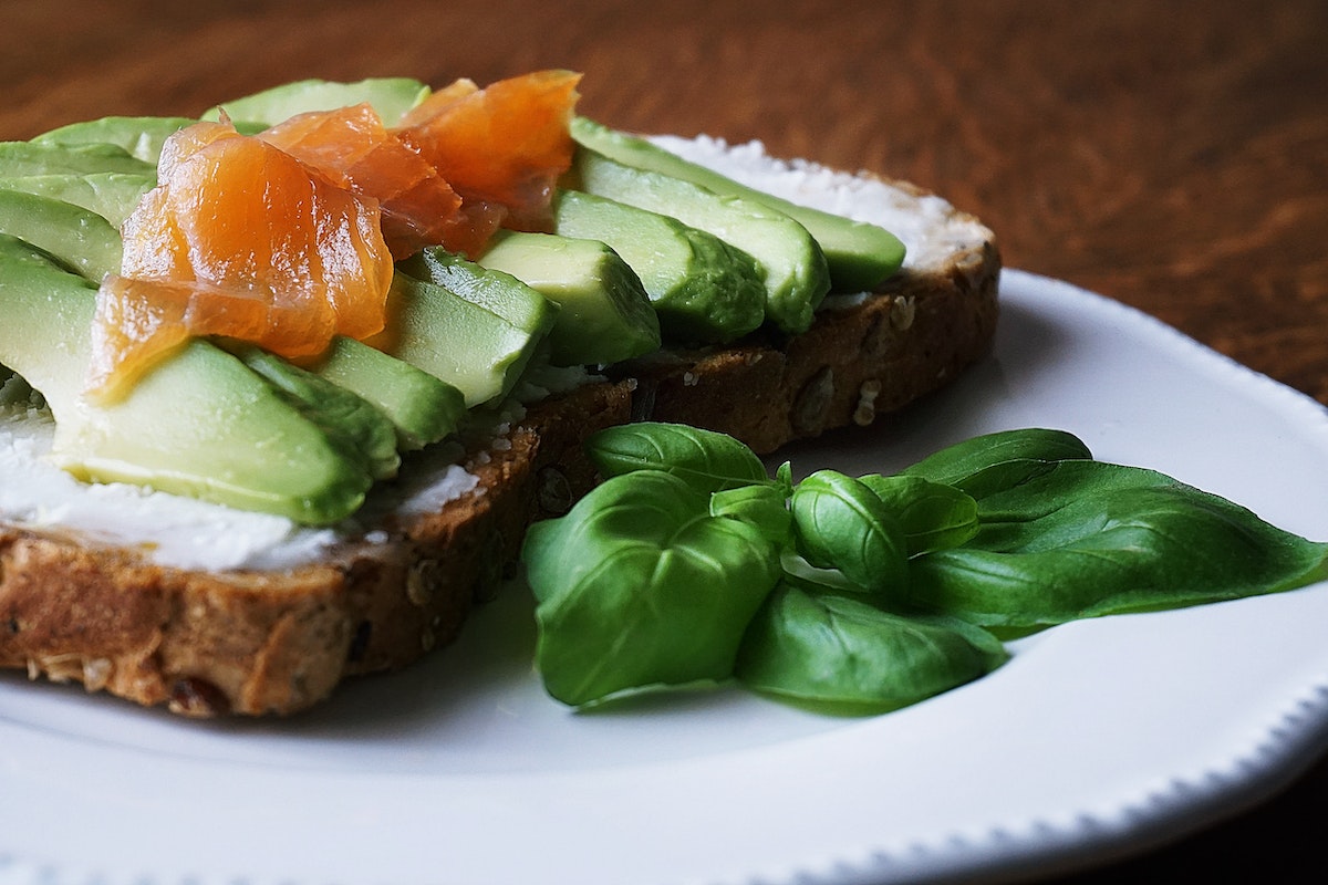 bread with sliced avocado and salmon