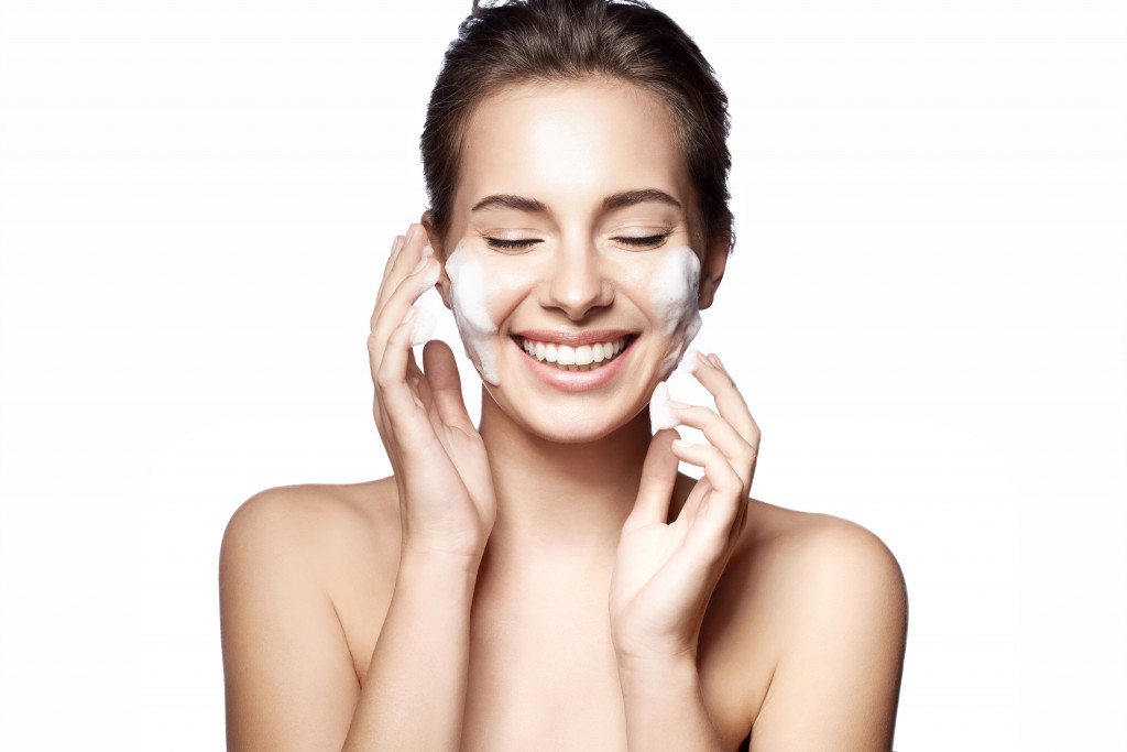 woman smiling happily while cleansing