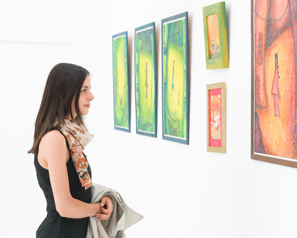 colorful framed paintings displayed on a white wall