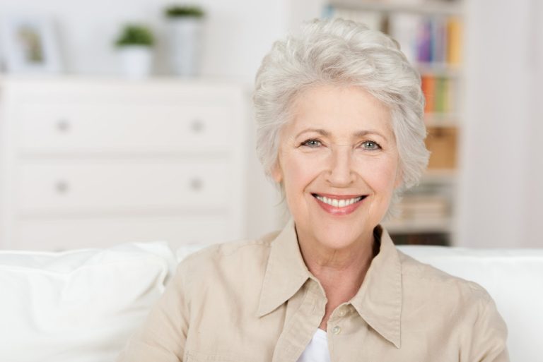 smiling elderly woman in her home