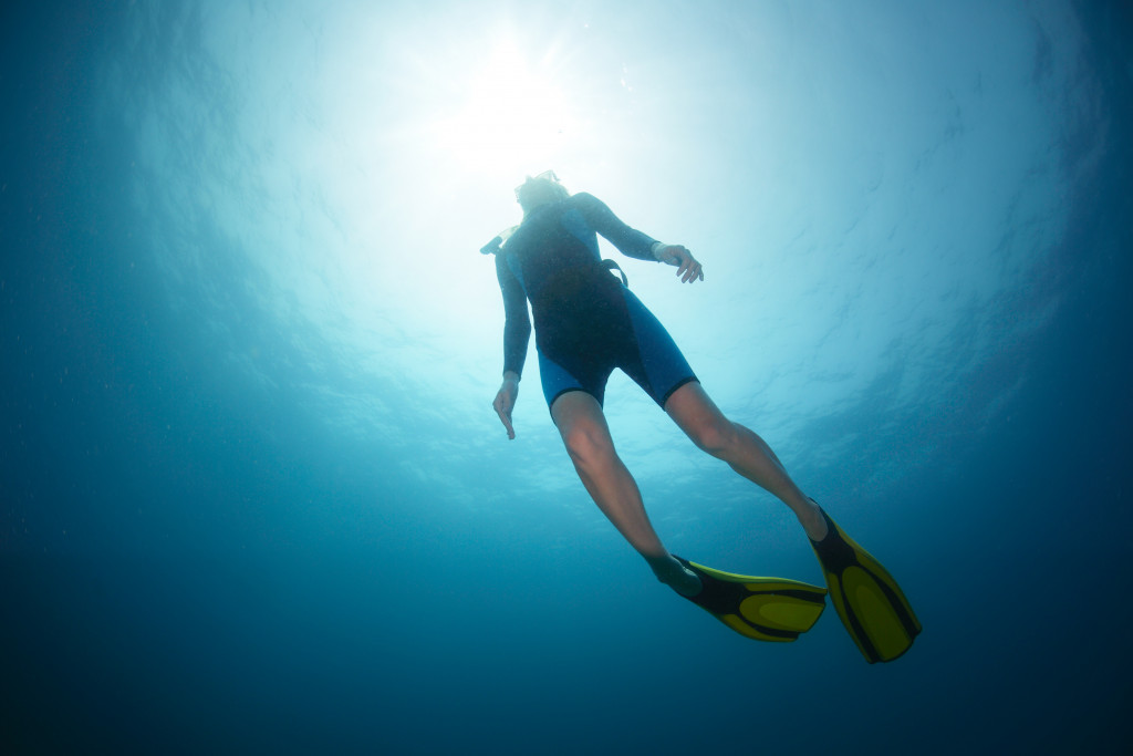 a man diving in a body of water