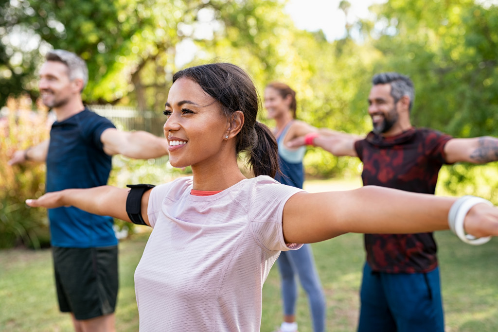 A group of adults working out outdoors