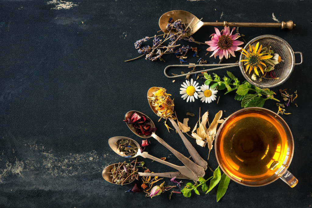 a picture of herbs and spices and oils being used for medicinal purposes